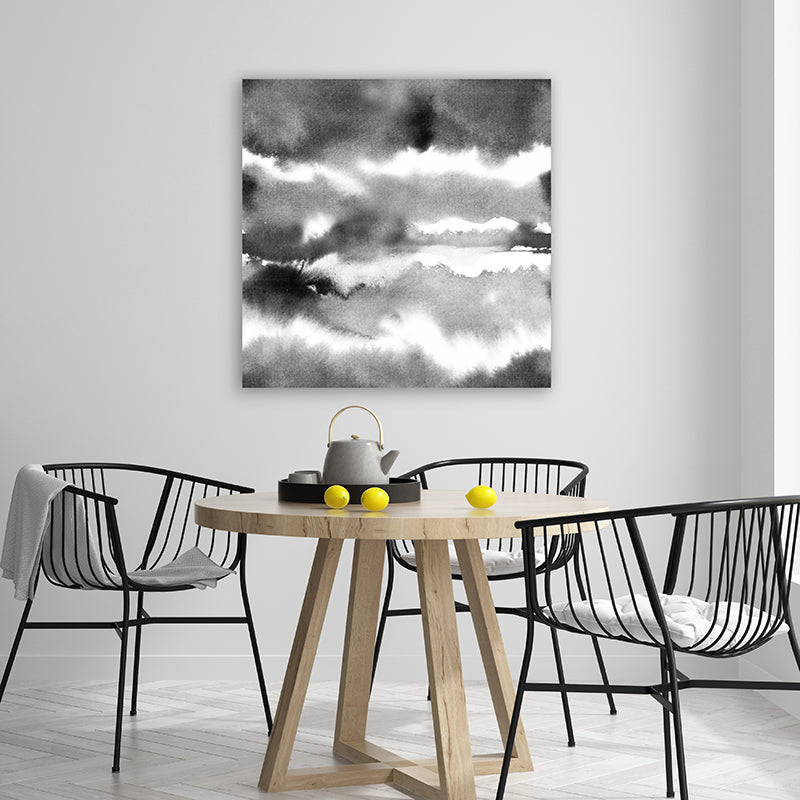 Abstract black and white framed art print with watercolour washes resembling clouds in a modern, minimalist dining room.