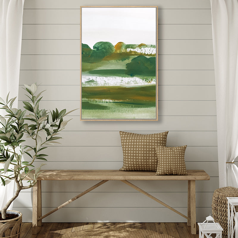 Canvas art print that evokes the beauty of a rural landscape in dark green and olive hues, in a farmhouse-style interior.  