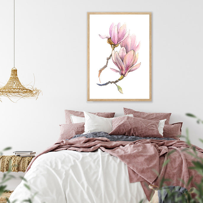 Framed art print of pink magnolias on a white background in a boho bedroom.